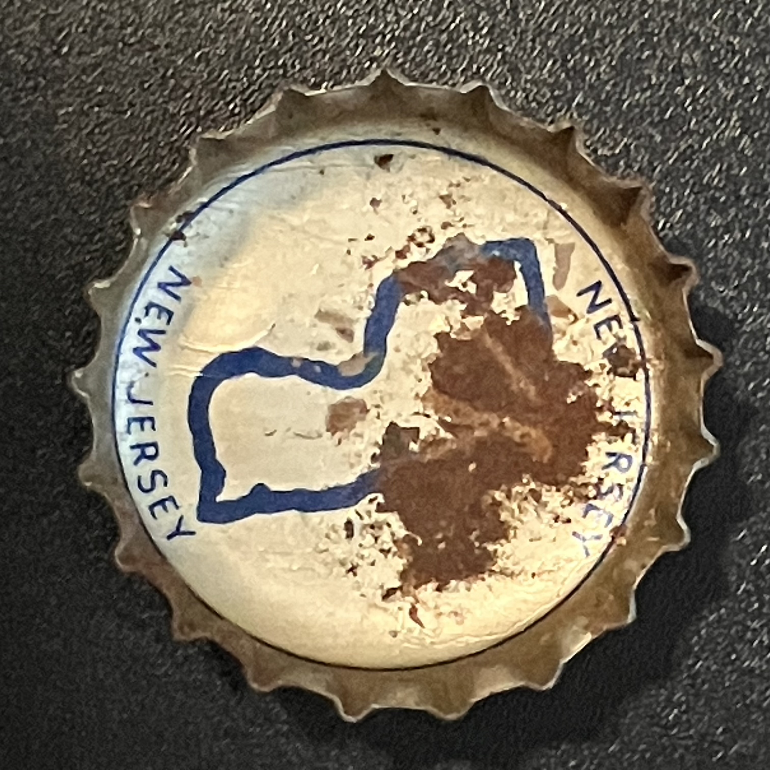 crown-cap liner of outlined map of New Jersey